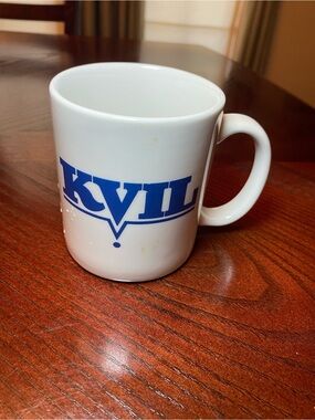 White Ceramic Coffee Mug with Blue KVIL Radio Logo. 10 Oz